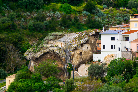 Facade of Domus de Janas La Rocca, famous house built in a boulder in Sedini village, north Sardinia Island, Italy