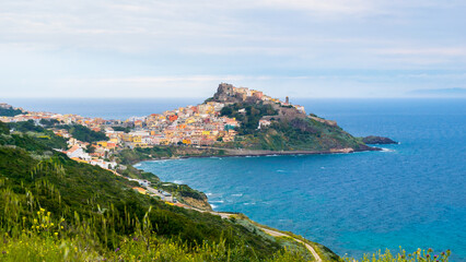 Fototapeta premium Panoramic view of Castelsardo, a colorful village on a small peninsula with a castle on the top, Sardinia Island, Italy