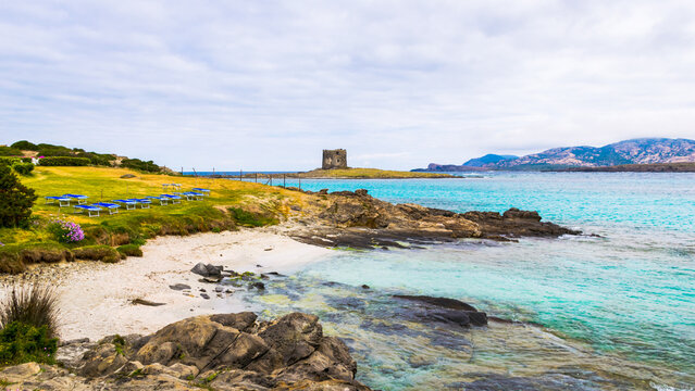 Panoramic view of small La Pelosetta beach with Isola della Pelosa island and Caletta della Torre tower on it, La Pelosa beach, Sardinia Island, Italy