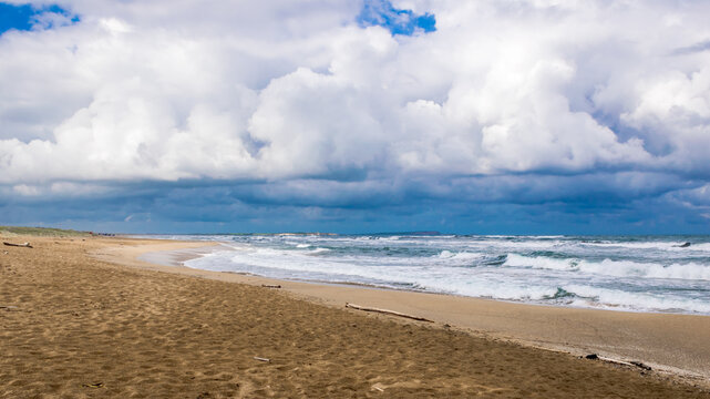 Early morning view of cloudy Is Arenas (or Sas Renas) sandy beach on the western side of Sardinia Island, Italy