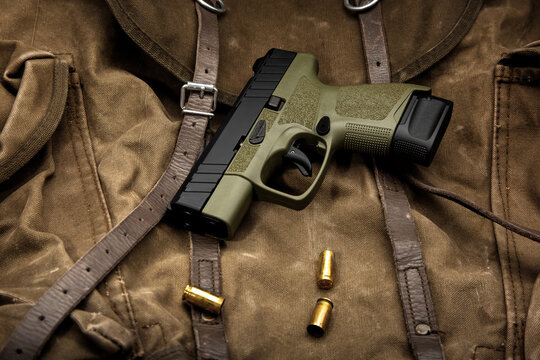 Compact handgun with empty brass casings