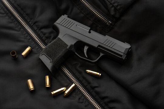 Semi automatic pistol on tactical jacket