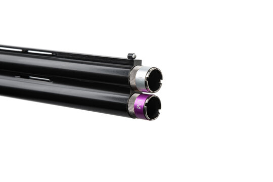 Close-up of a double-barrel shotgun muzzle with silver and purple choke tubes on white back