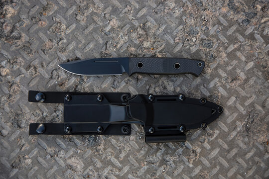 Tactical fixed blade knife with carbon fiber handle and kydex sheath on metal back