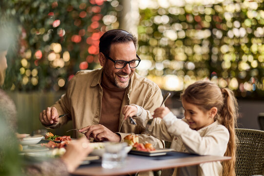 Father and Daughter Laughing Together Over Lunch at Outdoor Cafe Family Meal and Bonding