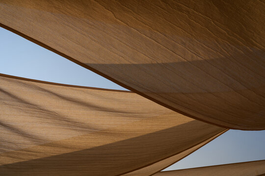 Geometric beige shade sails against blue sky at Fuxian Lake, Yunnan