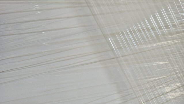 Dust-proof protective plastic wrap. Clear plastic film wrapped for dust and scratch protection. Featuring stretch wrap textures that ensure cleanliness and product safety.