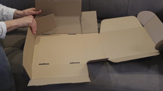 Cardboard box. Fold according to instructions. Self-assembly. Slow motion video. . High quality 4k footage