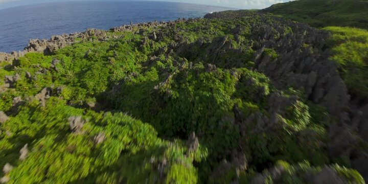 FPV drone flight over volcanic coastline and natural pools in Niue Island