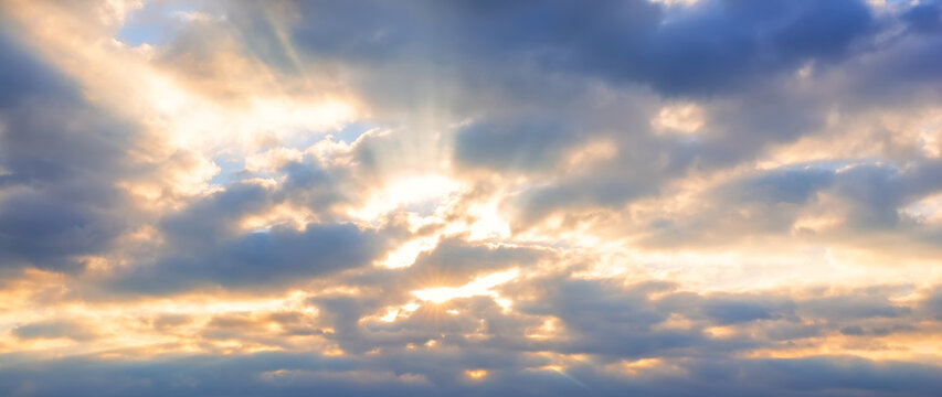 Cloudy sky with sun rays breaking through. Atmospheric natural background suitable for weather, spirituality and dramatic visual concepts.