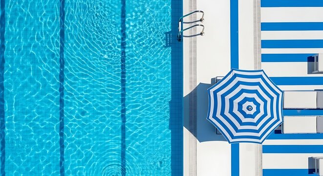 Aerial view of a swimming pool with a blue and white striped umbrella and lounge chairs