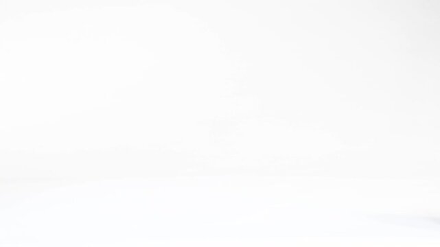 Miniature Soccer Balls Bouncing and Rolling Across a White Background