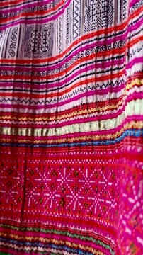 Handwoven ikat textile featuring colorful geometric patterns. Perfect for backgrounds, fashion, interior design, and cultural themes.