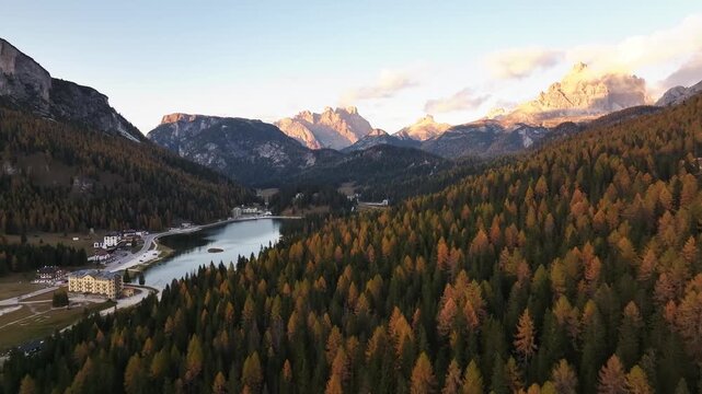 Scenic aerial view of fiery autumn colours in an alpine forest. Drone view of the Dolomites in the fall, near Lake Misurina