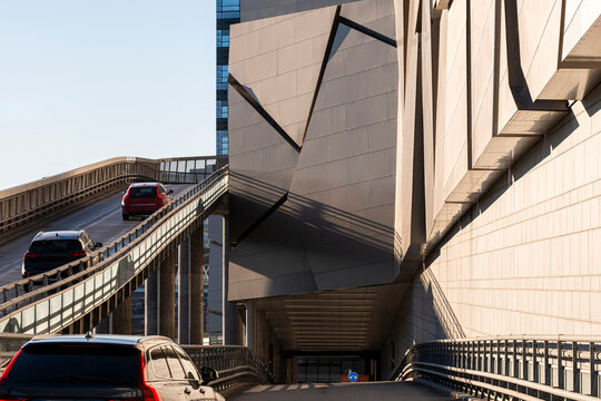 Modern urban architecture in Stockholm Sweden overlooks traffic as cars climb a road ramp with infrastructure built for fast city travel