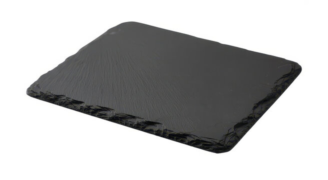 Rectangular black slate serving board with rough natural edges isolated on a white background