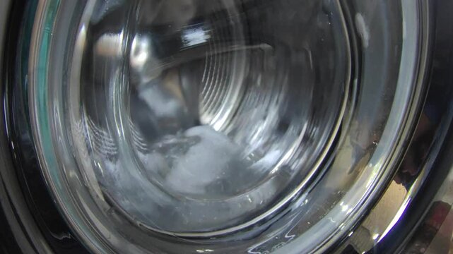 Water splashing inside a front load washing machine drum during rotation