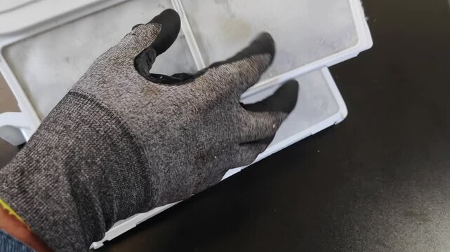 Close-up of removing a clogged lint filter from a modern clothes dryer
