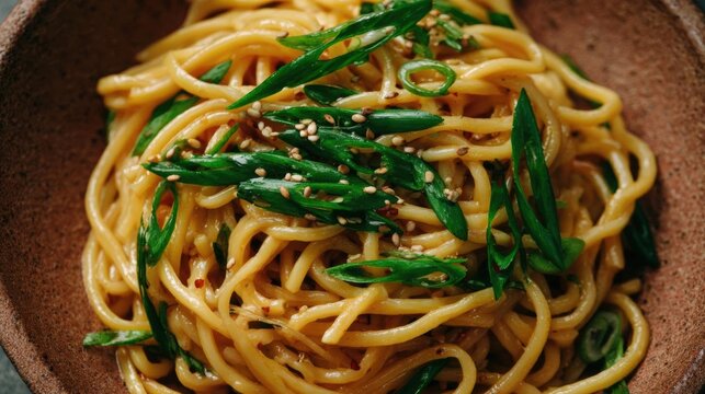 Close-up of a bowl of noodles. the noodles are long and thin, and they appear to be cooked al dente.