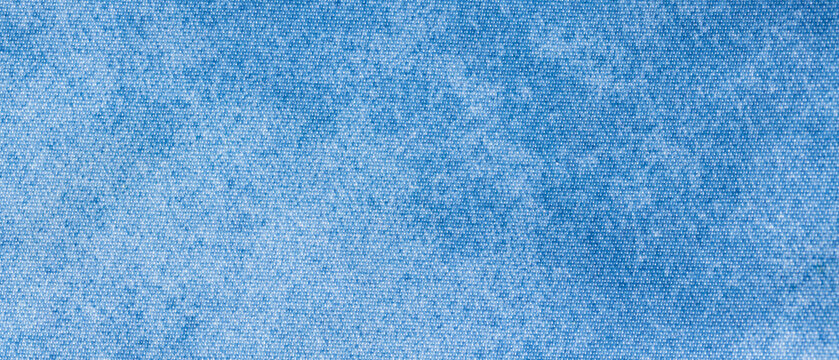 Light blue denim chambray fabric texture with fine woven surface as a background