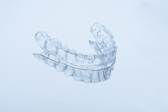 Orthodontic treatment represented by single transparent aligner tray, treatment requires consistent wear for weeks, treatment transforms misaligned teeth into straight beautiful smile over time.