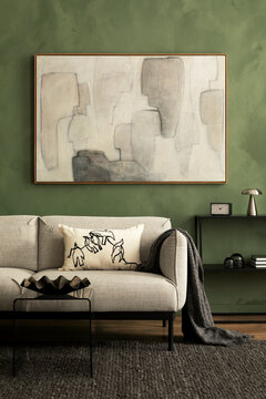 Modern living room interior with stylish light sofa, abstract art, green wall, and unique home decor items for a cozy atmosphere