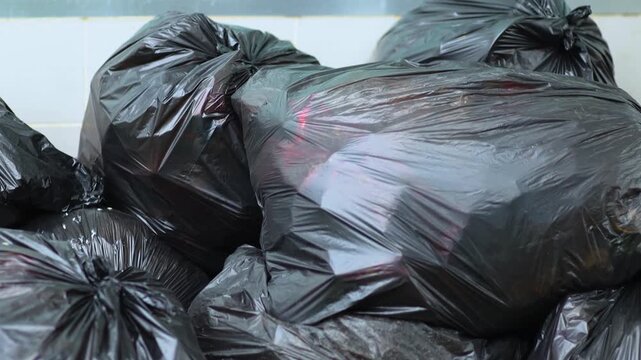 Pile of black plastic garbage bags for waste management and disposal