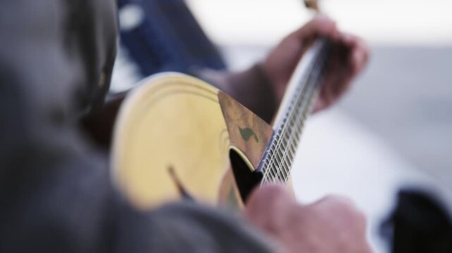 Man performance player play bouzouki outdoor  on street, isolated cinematic shot, slow motion