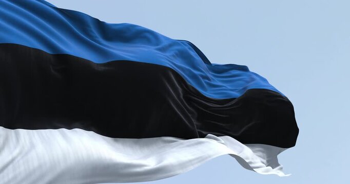 Close-up of national flag of Estonia waving in the wind n a clear day. Seamless 3d render animation. Slow motion loop. Selective focus