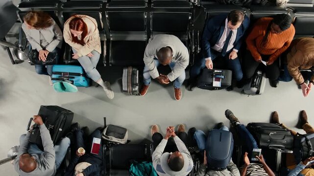 Agitated, top down view and gate agent giving delayed flights news to frustrated passengers in airport. Reacting to flight cancellation, announcement and annoyed group of multiethnic people