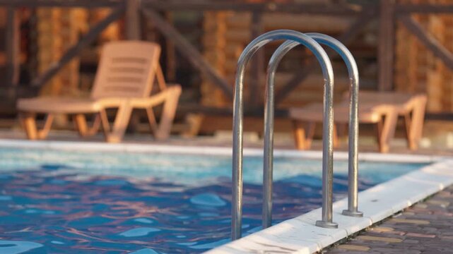 Top view of swimming pool with clear water on vacation on sunset background