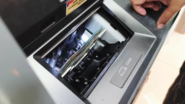 Close-up transaction process of withdrawing money from an ATM machine