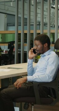 Man handling critical conversation in modern open workspace