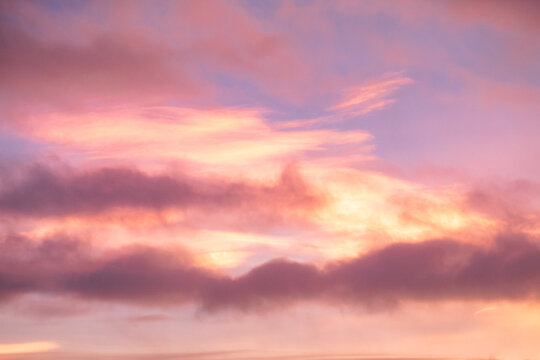 Rare iridescent nacreous cloud glowing in a pastel Arctic twilight sky above dark clouds, soft atmospheric winter scene in Norway