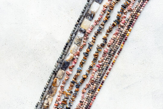 Jewelry and precious concept. Gemstones and beads for necklace, top view, flat lay