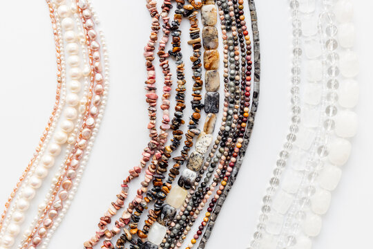 Precious and jewelry flat lay background. Lots of gemstones for necklace and bracelets, top view