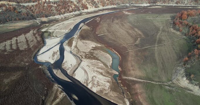Dried lake and river in autumn because of agriculture irrigation, water crisis, climate change or drought concept.