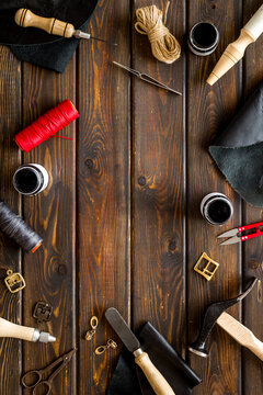 Frame flat lay of leather craftsman or shoemaker tools and equipment, top view