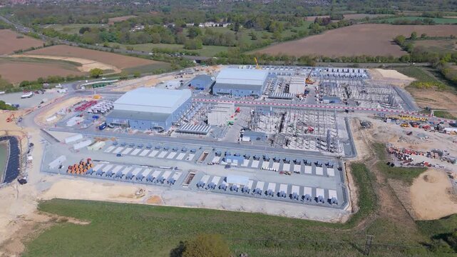Drone orbit movement of the construction of a large onshore BESS site in Norwich, UK.  This will receive power generated from offshore wind farms, convert and either store or distribute to the grid
