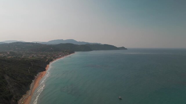 Aerial Drone Flight Over Arillas Bay Beach and Coastline Toward Afionas Corfu Greece