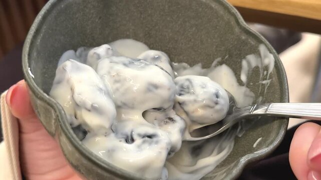 prunes with cream and sour cream dessert in ceramic plate with nuts rustic sweet dish 