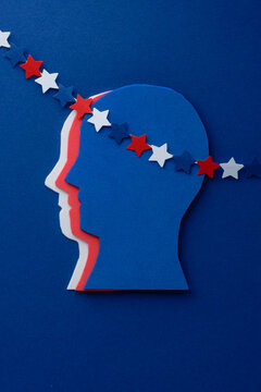Creative concept of a human head with decorated with a garland of stars on a blue background. Creative concept of American patriotism, July 4th celebration. Independence day. top view