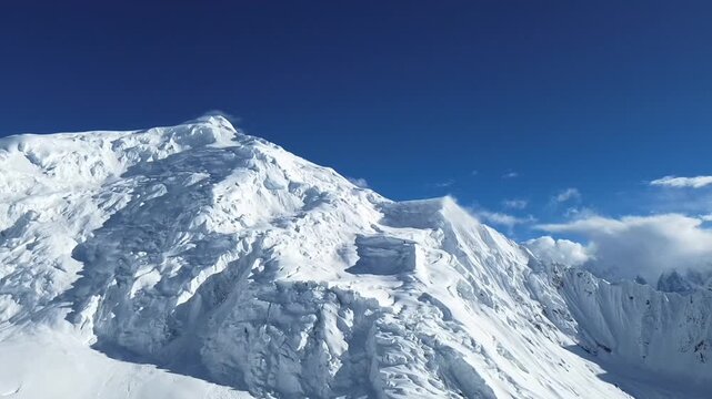 Cinematic footage of snow-covered mountains and glacial valleys, emphasizing the harsh yet beautiful conditions of a high-altitude wilderness.