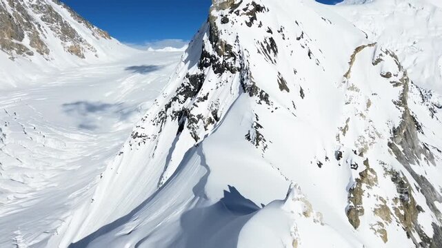 High-resolution footage of a frozen alpine world, with dramatic peaks, deep glacier formations, and a sense of isolation and exploration.