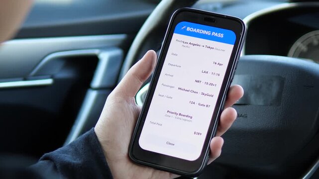 Traveler checking digital boarding pass on smartphone before heading to the airport. High-quality footage of mobile travel tech for an international flight. Perfect for vacation and business trip