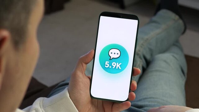 Skyrocketing community engagement. User watches a surge of 10K messages on a smartphone screen. Ideal for app promos, social media strategy, and online interaction stories. Trending visual for the