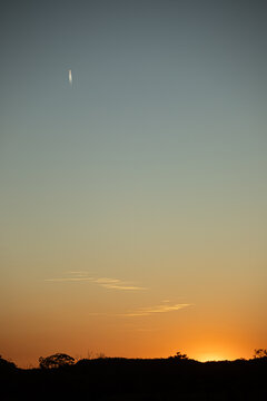Golden sunset with short jet trail in a big sky