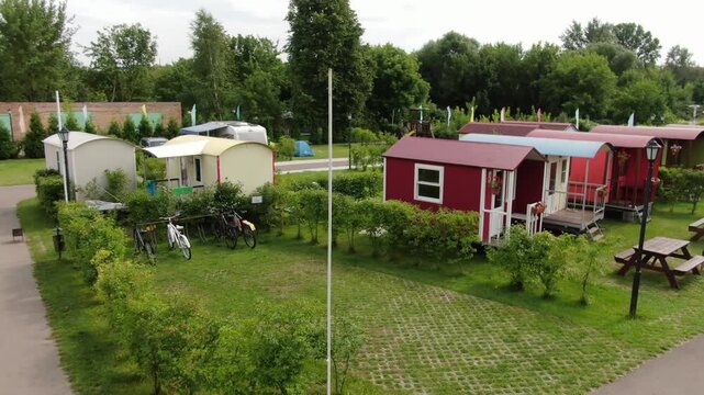 Drone flying low around campsite with small houses