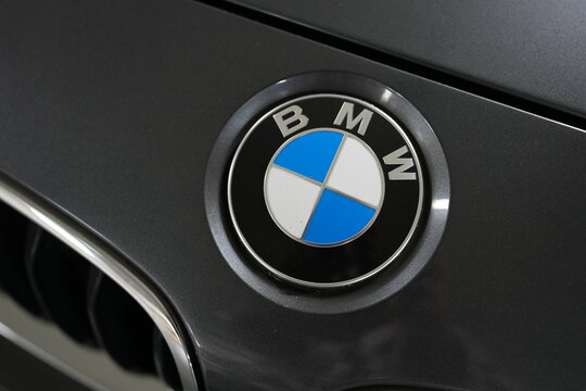 A close-up view of the BMW emblem on a car hood.