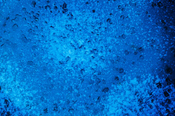 Fototapeta premium Water with bubbles in blue color fills the surface creating a unique pattern and texture